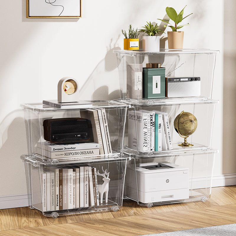 Clear, stacked Marcolo storage bins used as shelving for books and electronics.