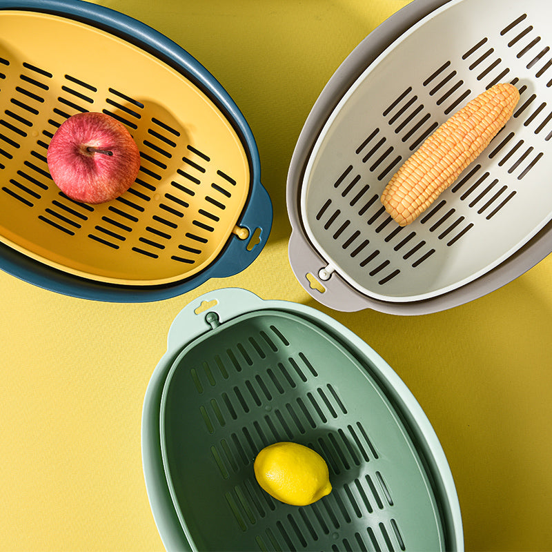 Three Marcolo colorful plastic colanders with fruit and corn.