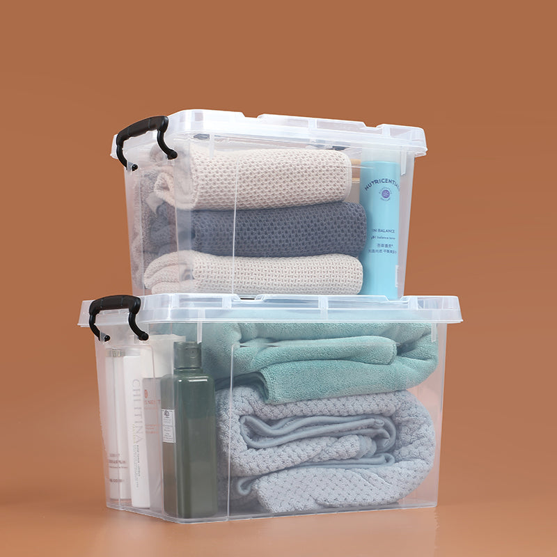 Marcolo set of two clear storage boxes stacked with towels.