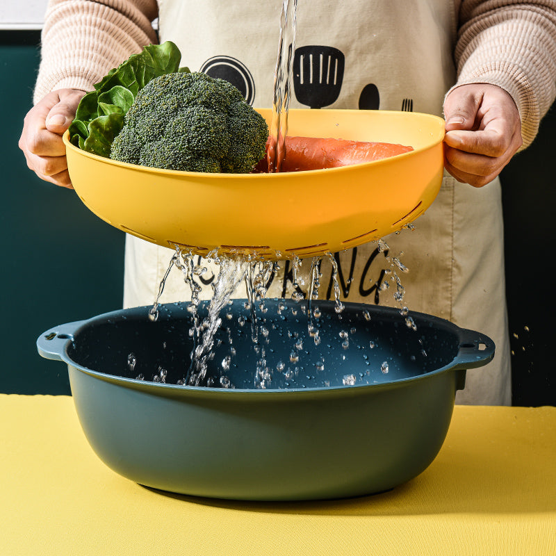 Marcolo dual-layer colander washing vegetables under water.