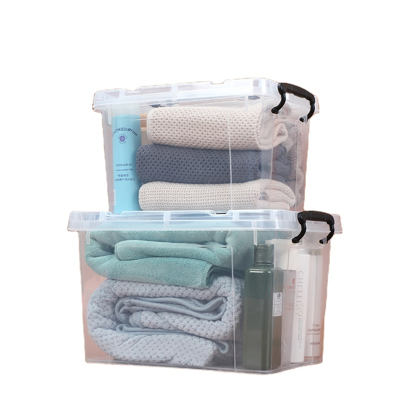 Marcolo two clear storage boxes stacked with blankets and toiletries.