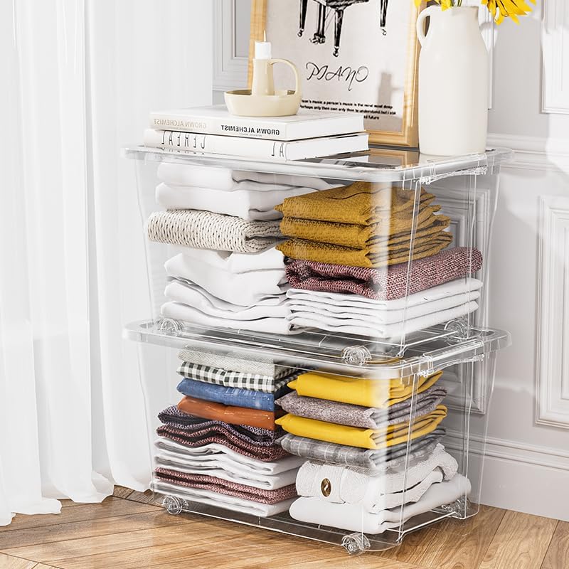 Two stacked clear storage boxes filled with folded clothes.
