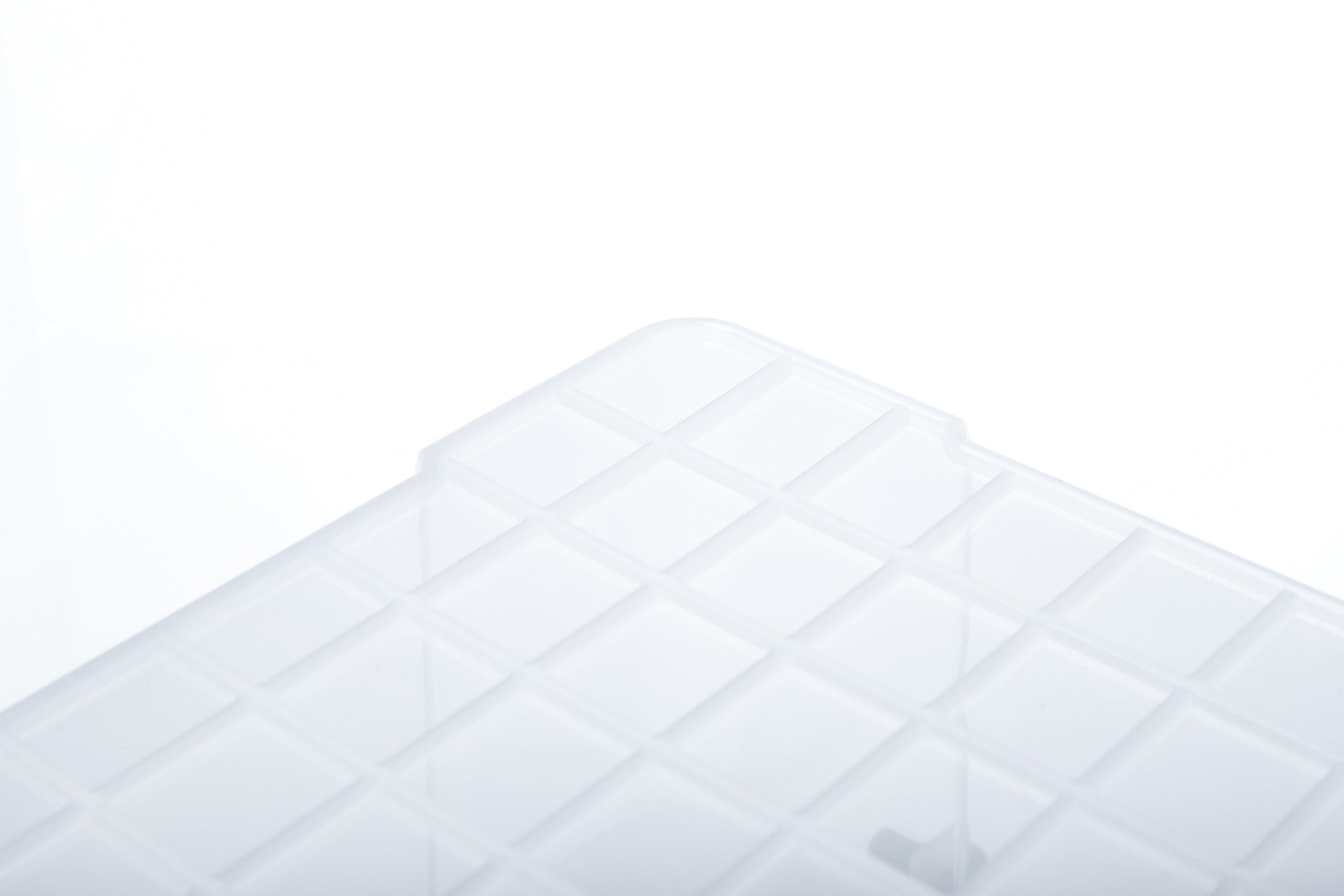 Close-up of a clear, square-gridded Marcolo plastic tray lid.