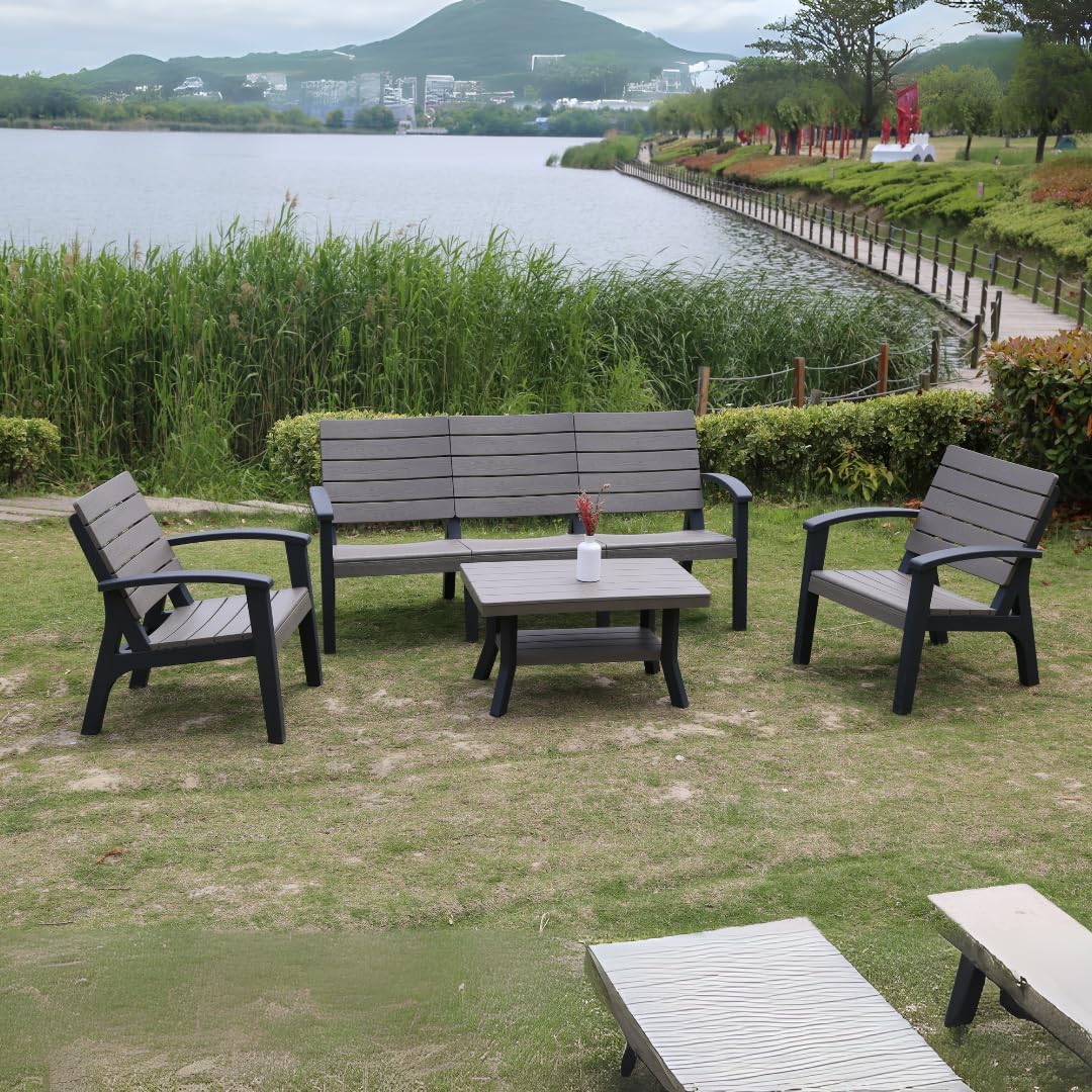 Gray and black 4-piece plastic patio furniture set on grass.