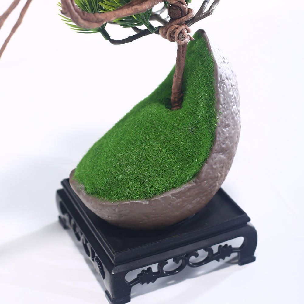 Marcolo artificial pine tree on a sloped green mossy base.