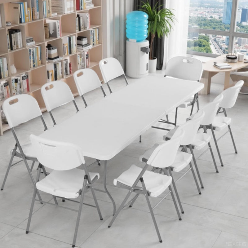 Long white Marcolo folding table with folding chairs.