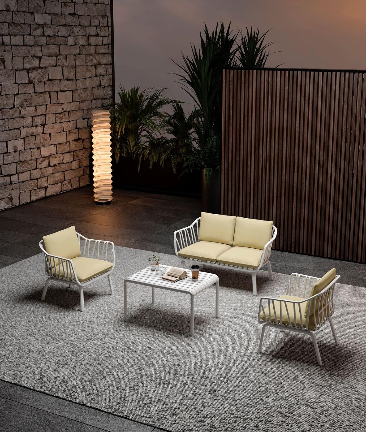 Marcolo 4-piece white outdoor furniture set with yellow cushions.