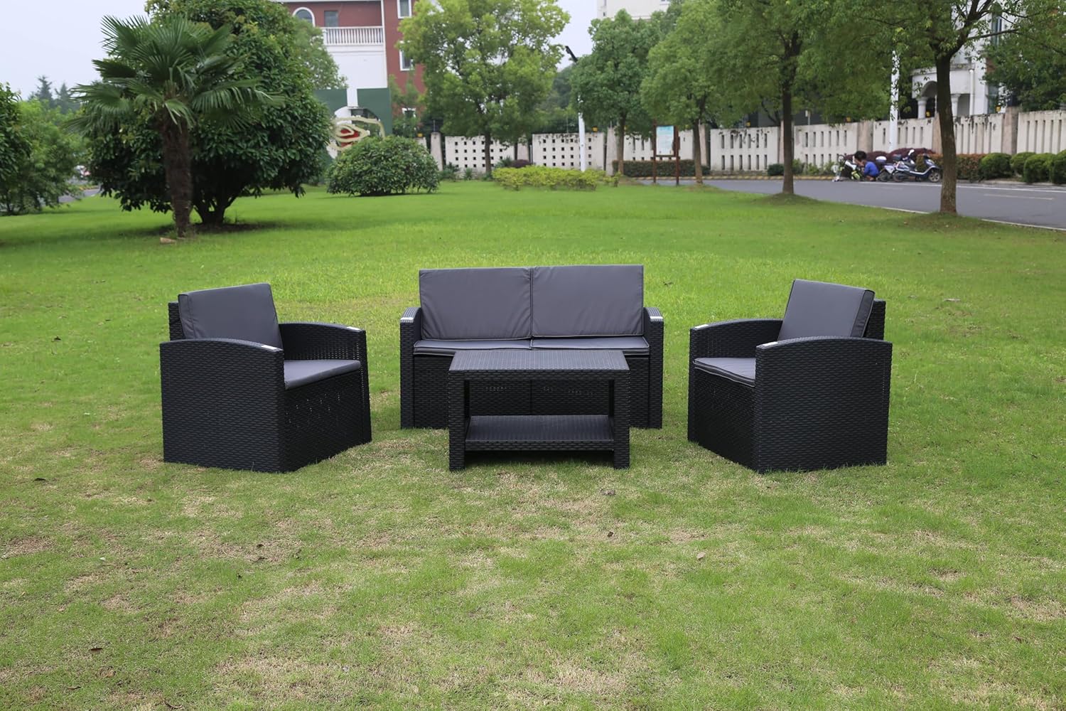 Marcolo black rattan 4-piece patio set on grass.