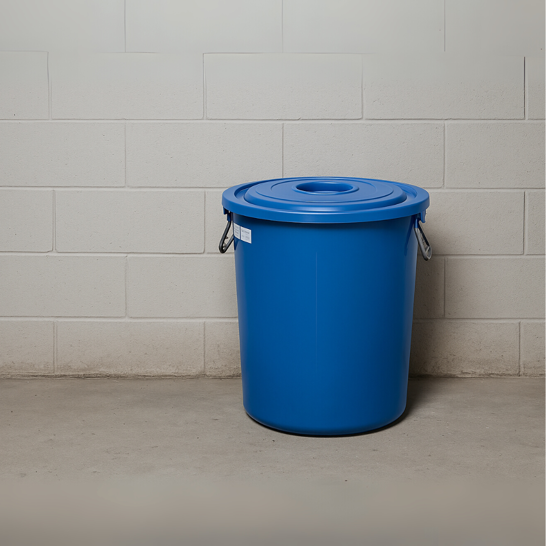 Blue plastic Marcolo bin with lid, against a white wall.