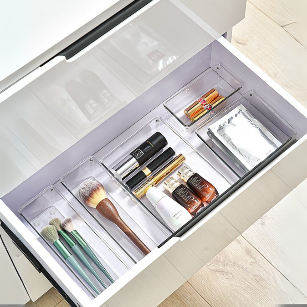 Marcolo clear drawer organizers holding makeup and brushes.