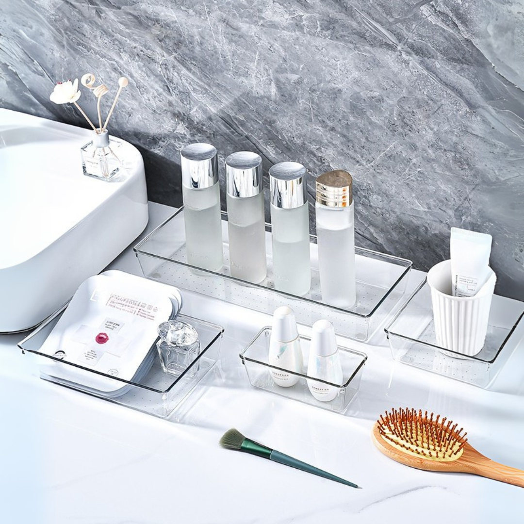 Marcolo clear acrylic bathroom organizer set with products.