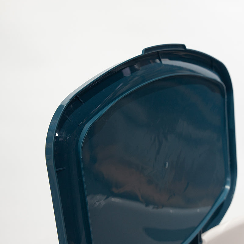 Close-up of the underside of a dark teal Marcolo trash can lid.