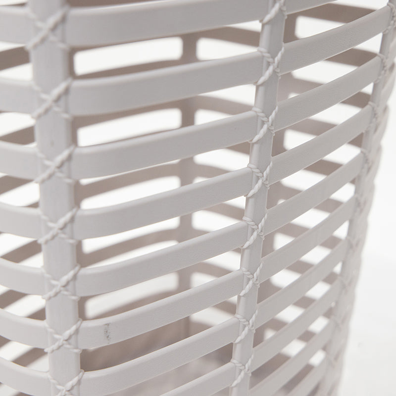 Close-up of the woven plastic texture of a white Marcolo laundry basket.