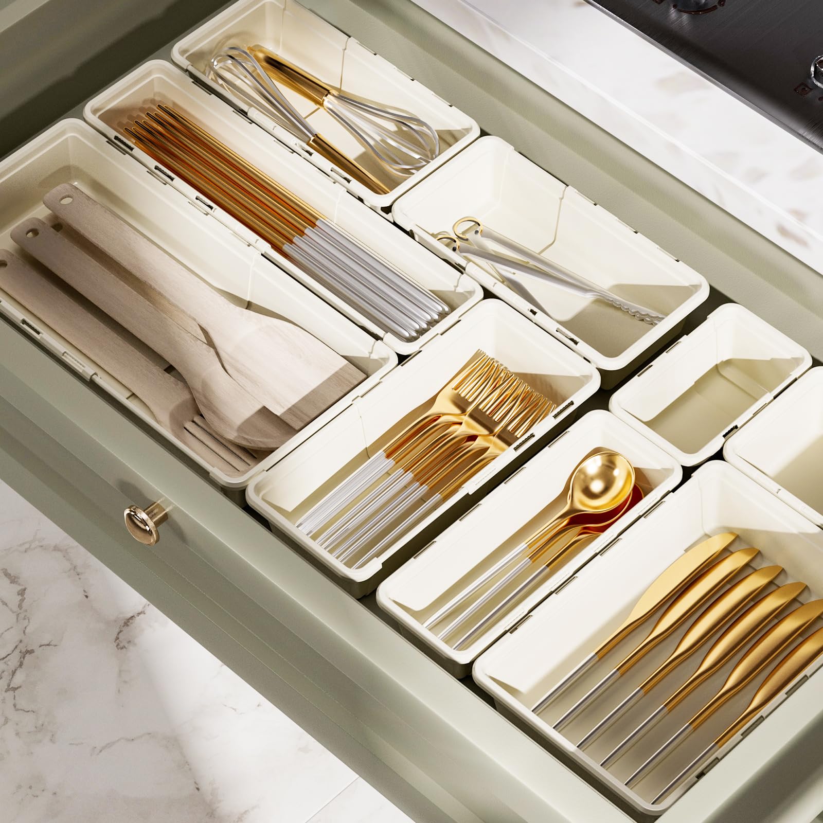 Marcolo drawer organizers holding gold and white cutlery.