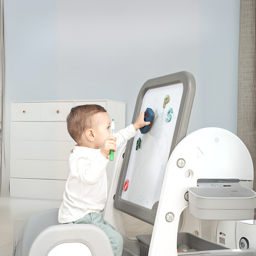 Toddler playing at a Marcolo child's easel with a magnetic board.