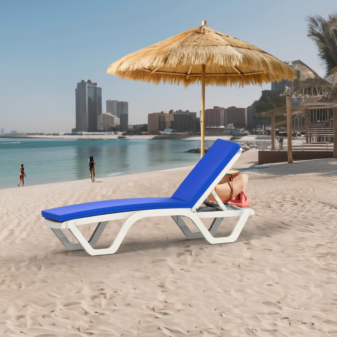 A white and blue Marcolo lounge chair under a straw umbrella on a beach.