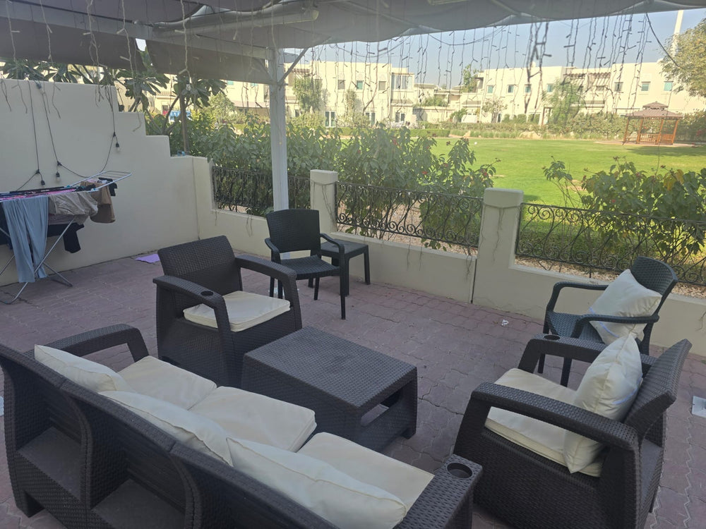 Customer's dark brown Havana rattan-look sofa set with cream cushions on a covered villa terrace