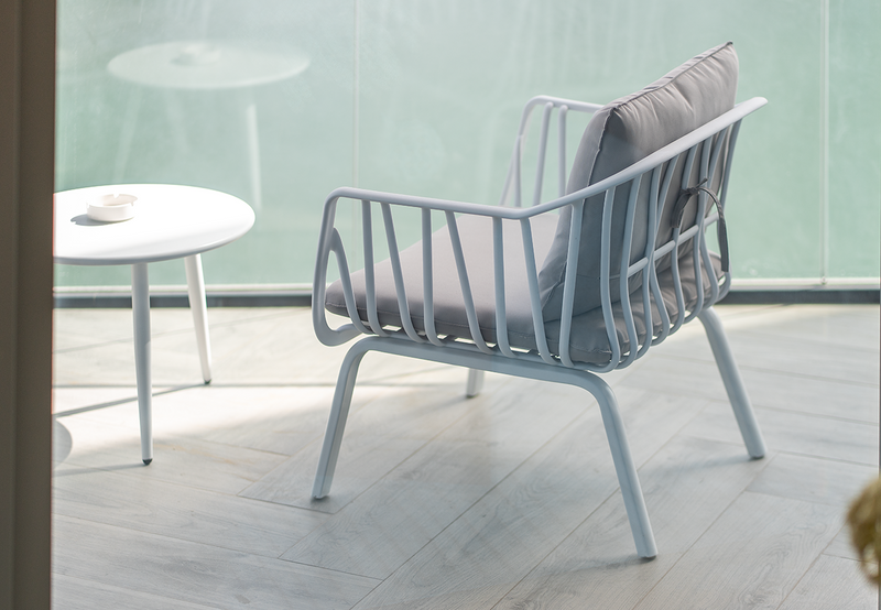 Marcolo white outdoor lounge chair with grey seat and back cushion.