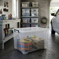 Marcolo 180L clear storage box with wheels in a garage, filled with magazines