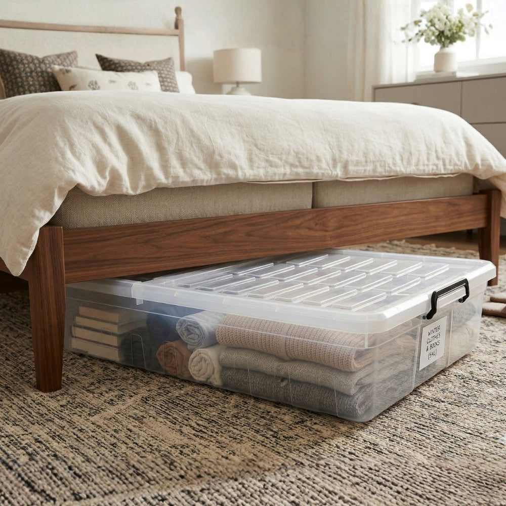 Marcolo 66L slim underbed storage box with wheels under a bed, filled with bedding