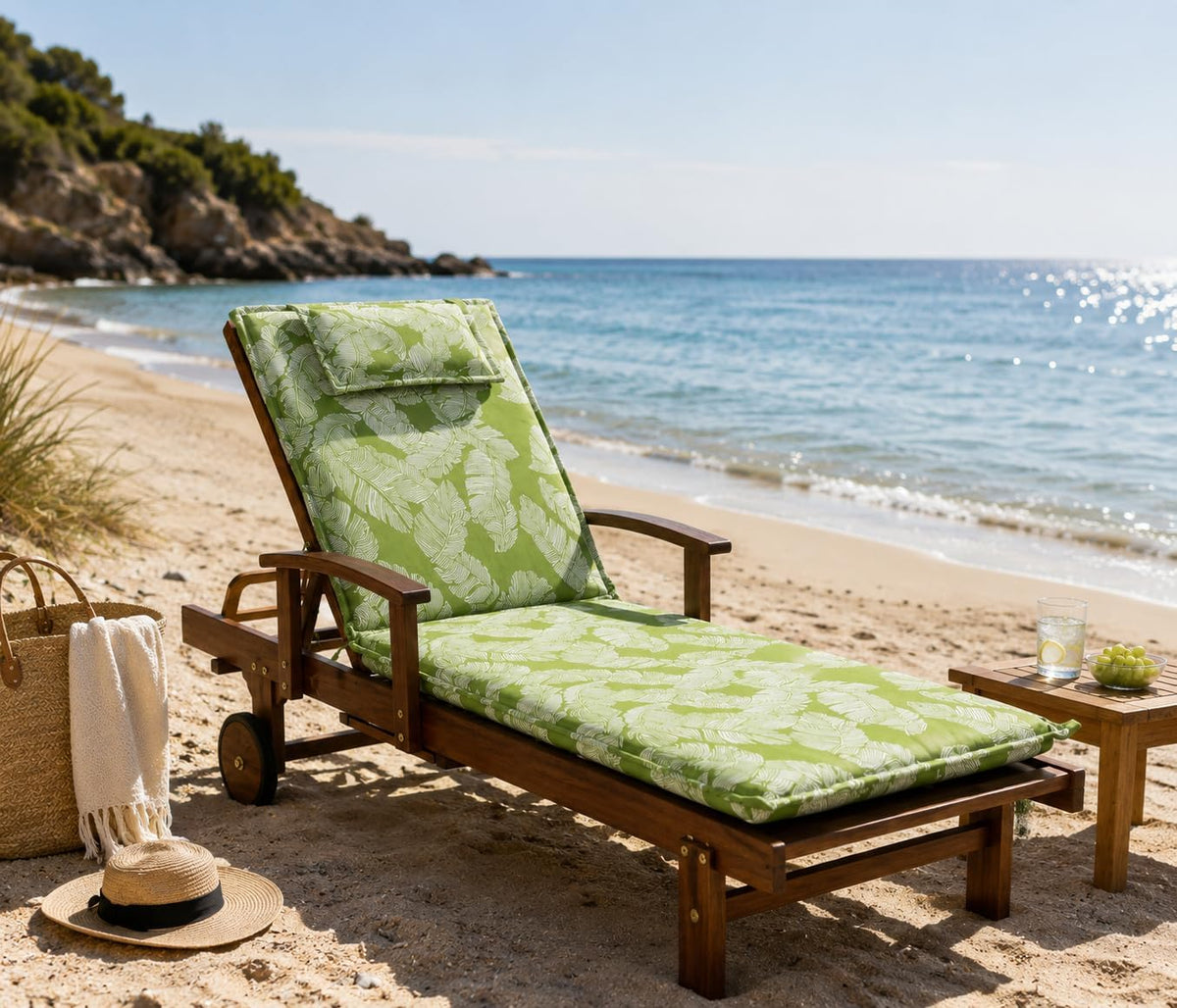 Phuket wooden sun lounger with green leaf cushion outdoors