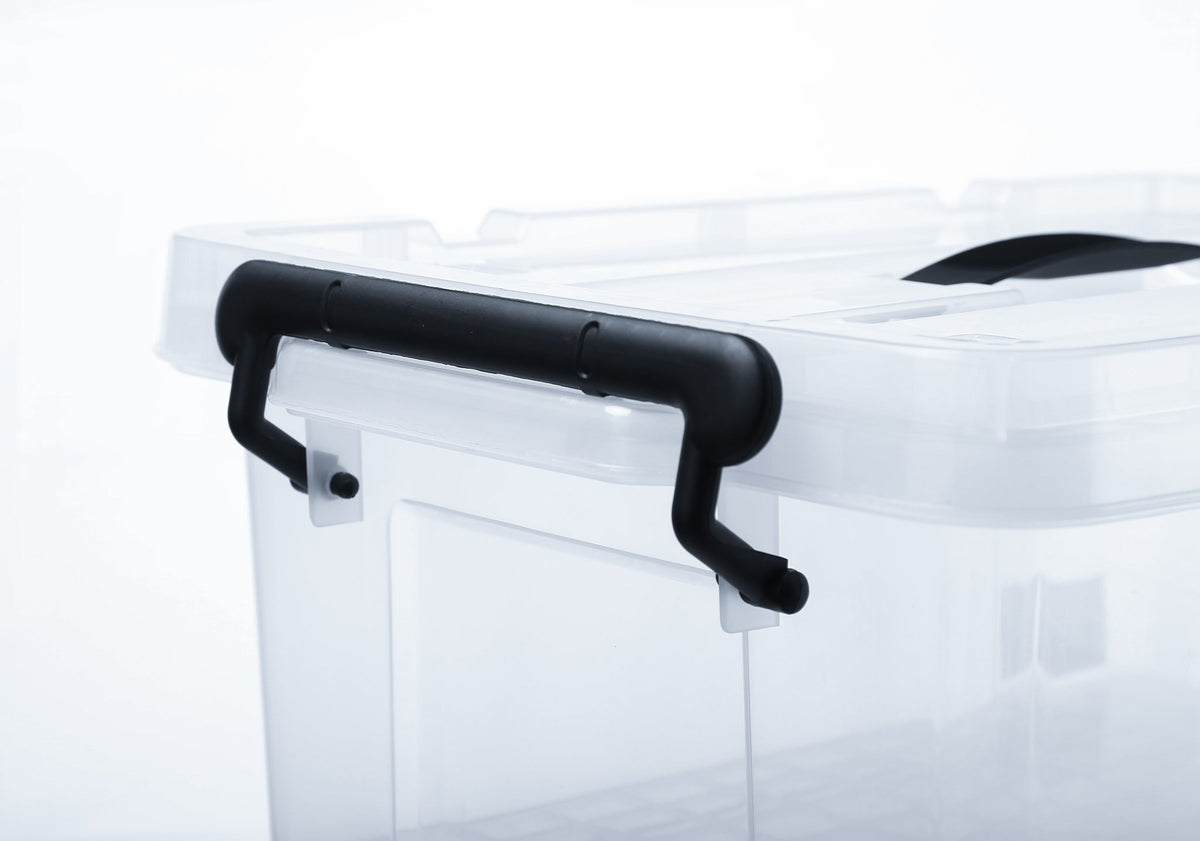Close-up of a black locking clip on a clear plastic storage bin.