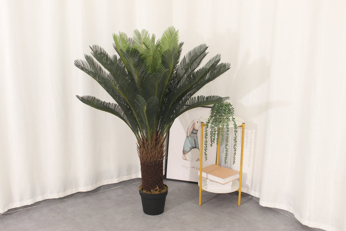 Marcolo 120 cm artificial sago palm in a room beside a side table