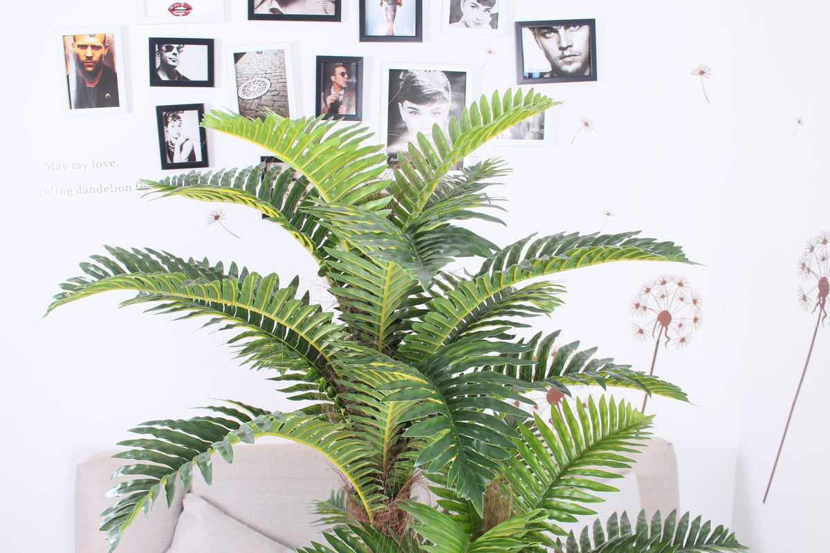 Close-up of the fronds on the Marcolo 150 cm artificial palm tree in a room