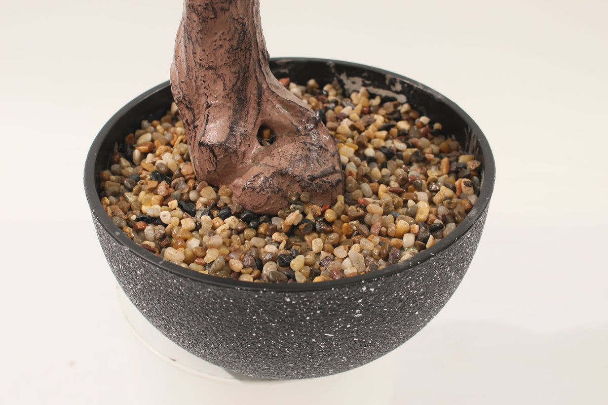 Base of the Marcolo 50 cm artificial pine bonsai in a speckled bowl with pebbles