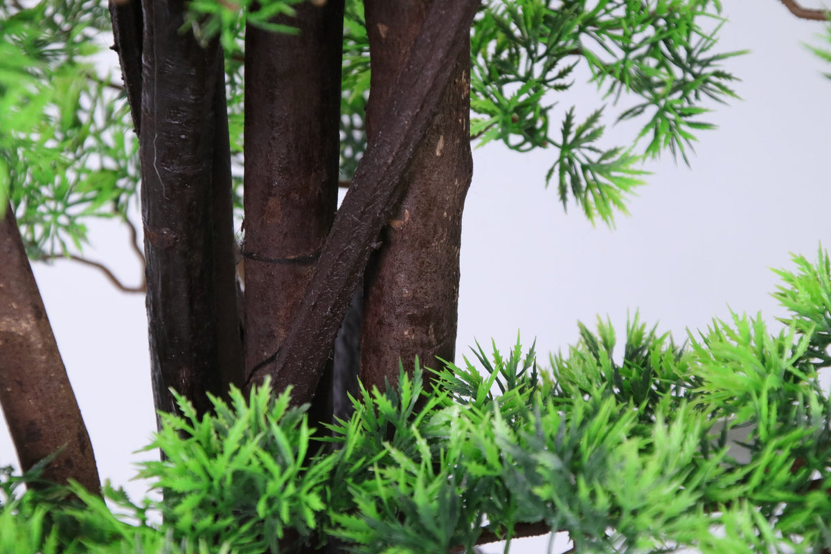 Marcolo 150cm artificial pine tree in a black plant pot.