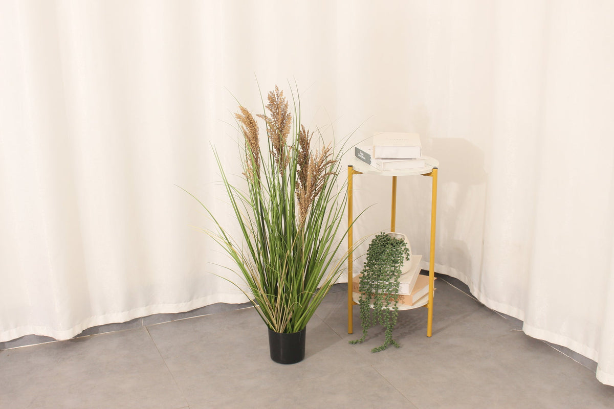 Marcolo 90cm artificial grass plant in a cozy room corner.