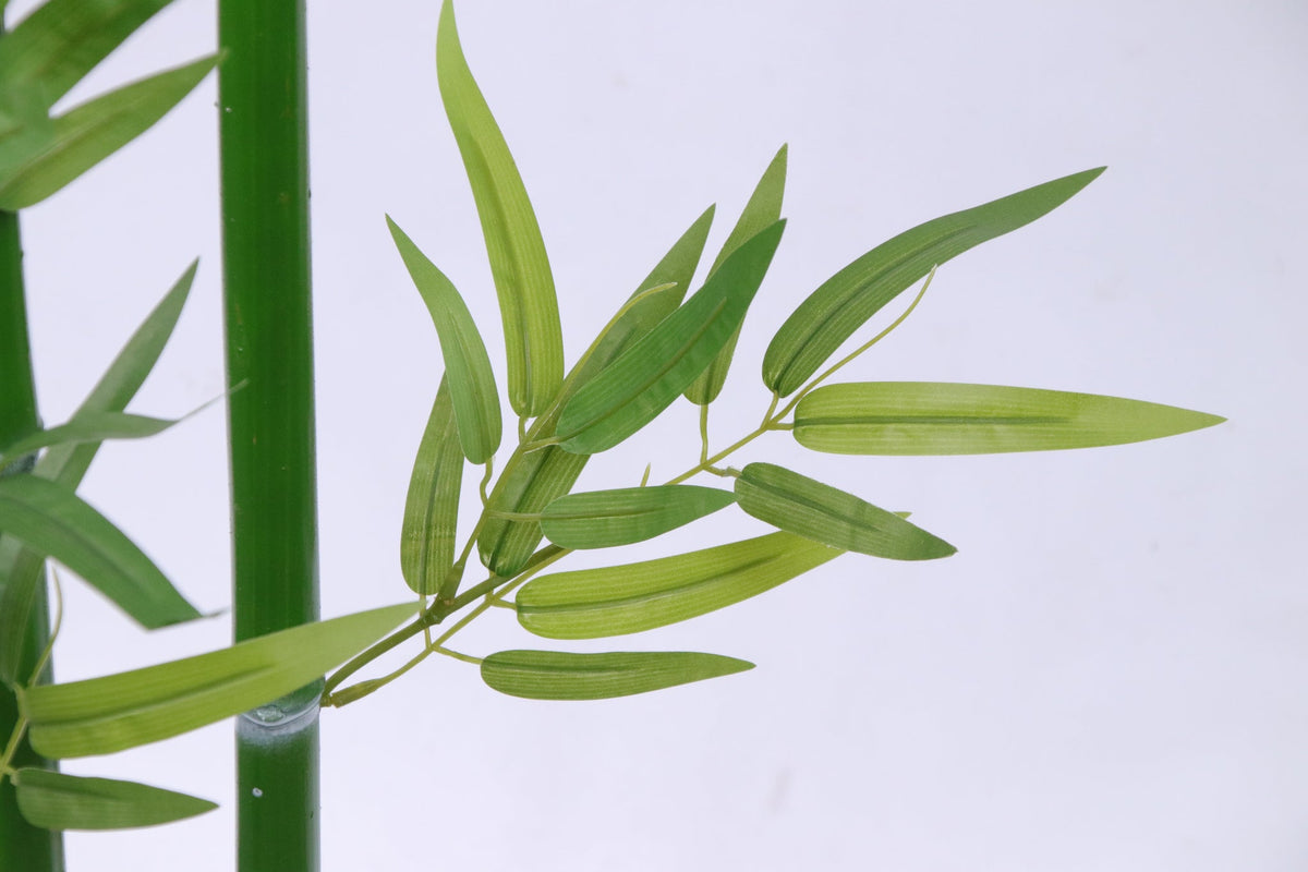 Marcolo artificial bamboo leaves with realistic long, narrow blades in a vibrant green hue.