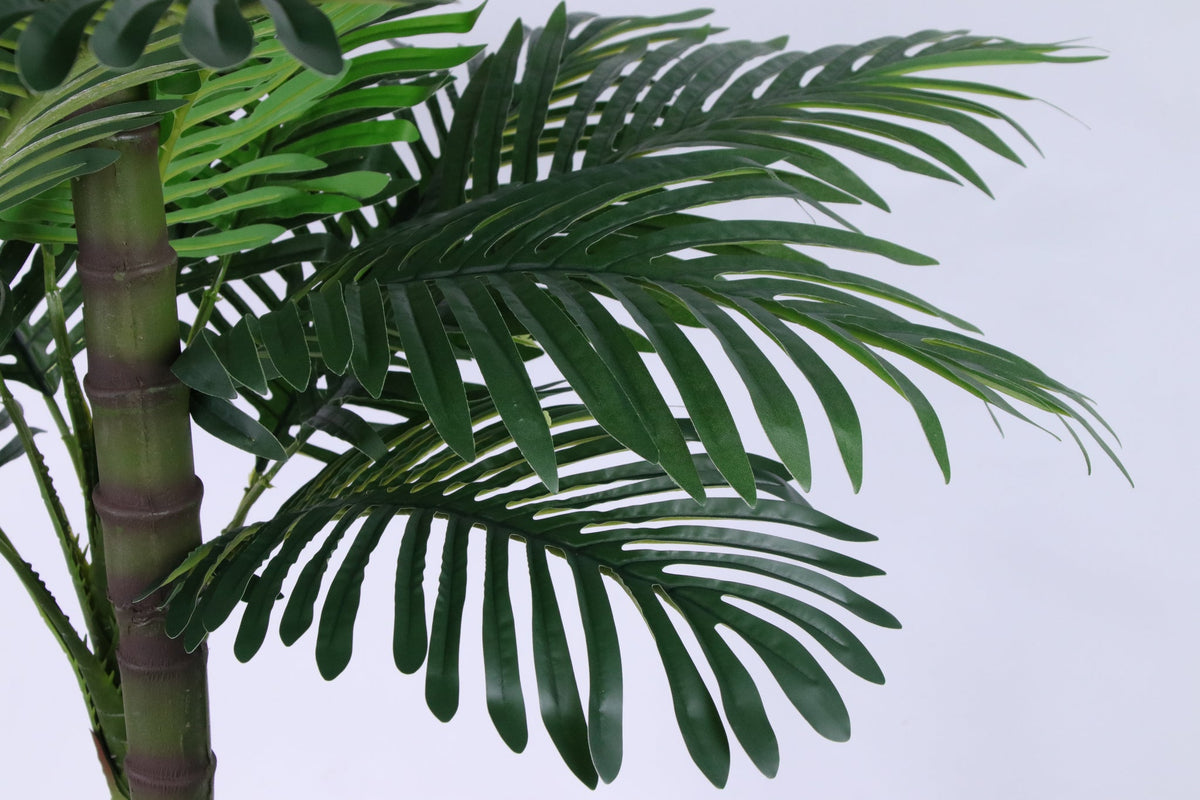 Marcolo artificial palm tree lush green fronds close-up.
