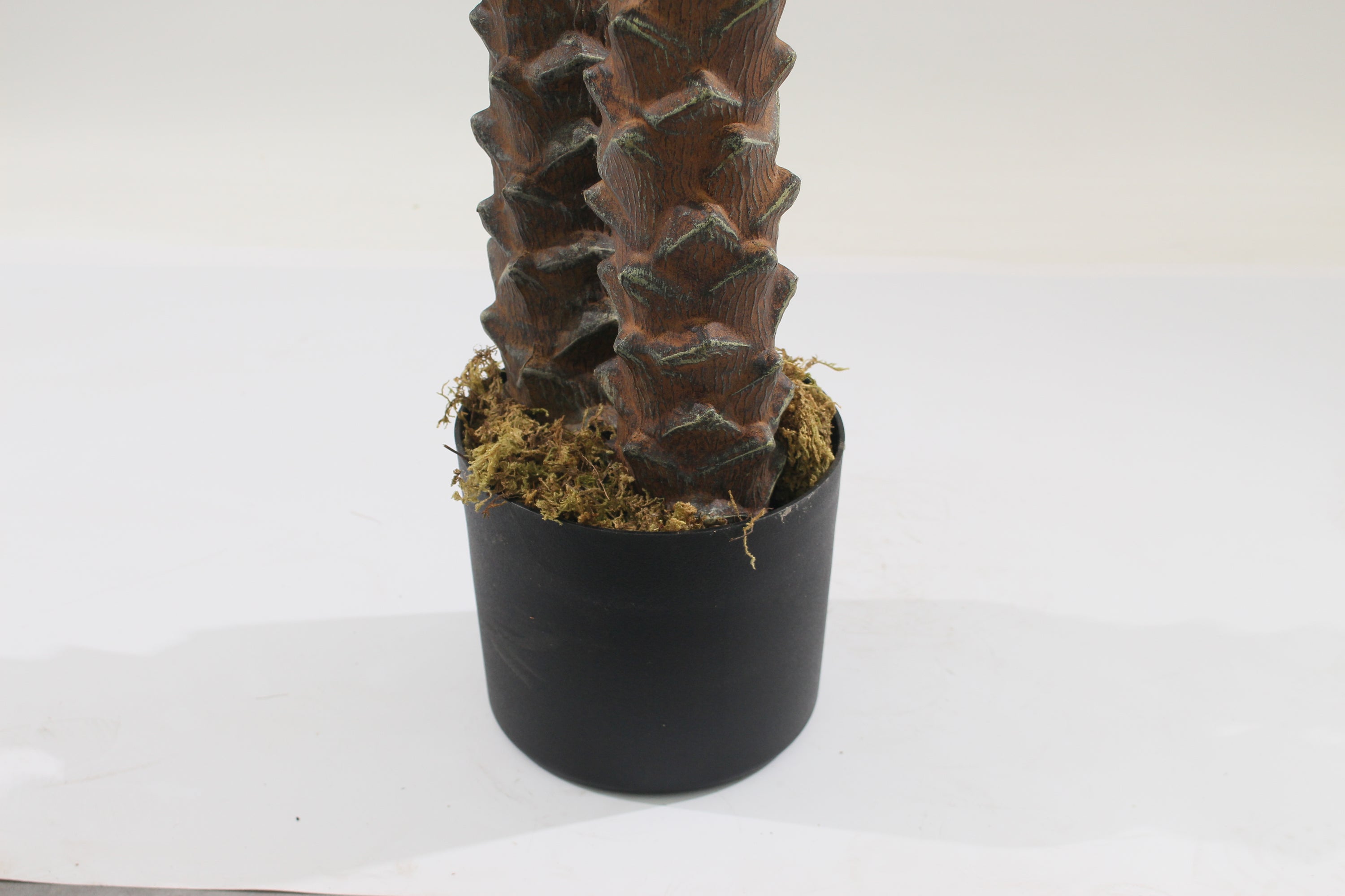 Marcolo 210cm artificial palm tree trunk in a black pot.