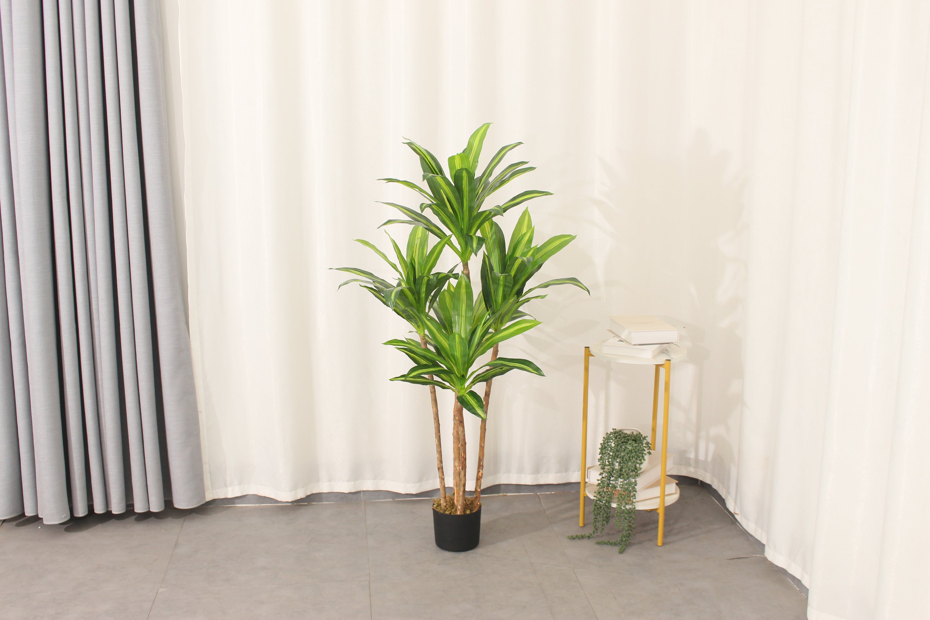 Marcolo artificial Dracaena tree in a home interior setting.