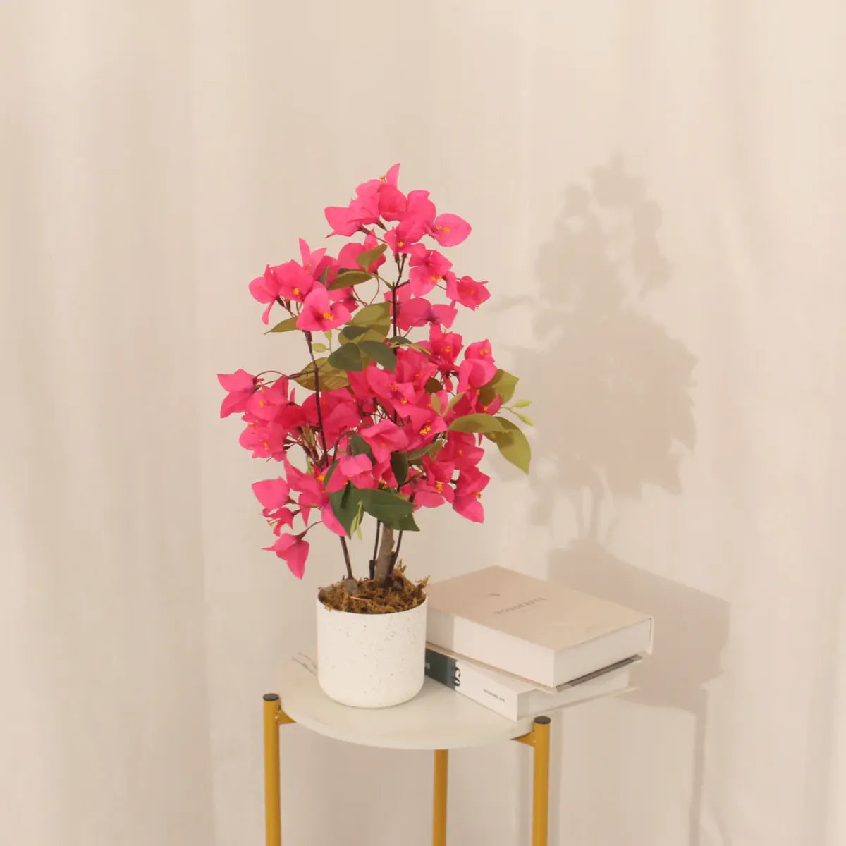 Artificial bougainvillea tree 50cm in a white pot on a side table, a vibrant indoor accent by Marcolo.