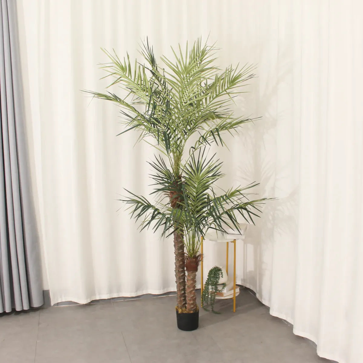 Marcolo 210cm artificial palm tree in a black pot.