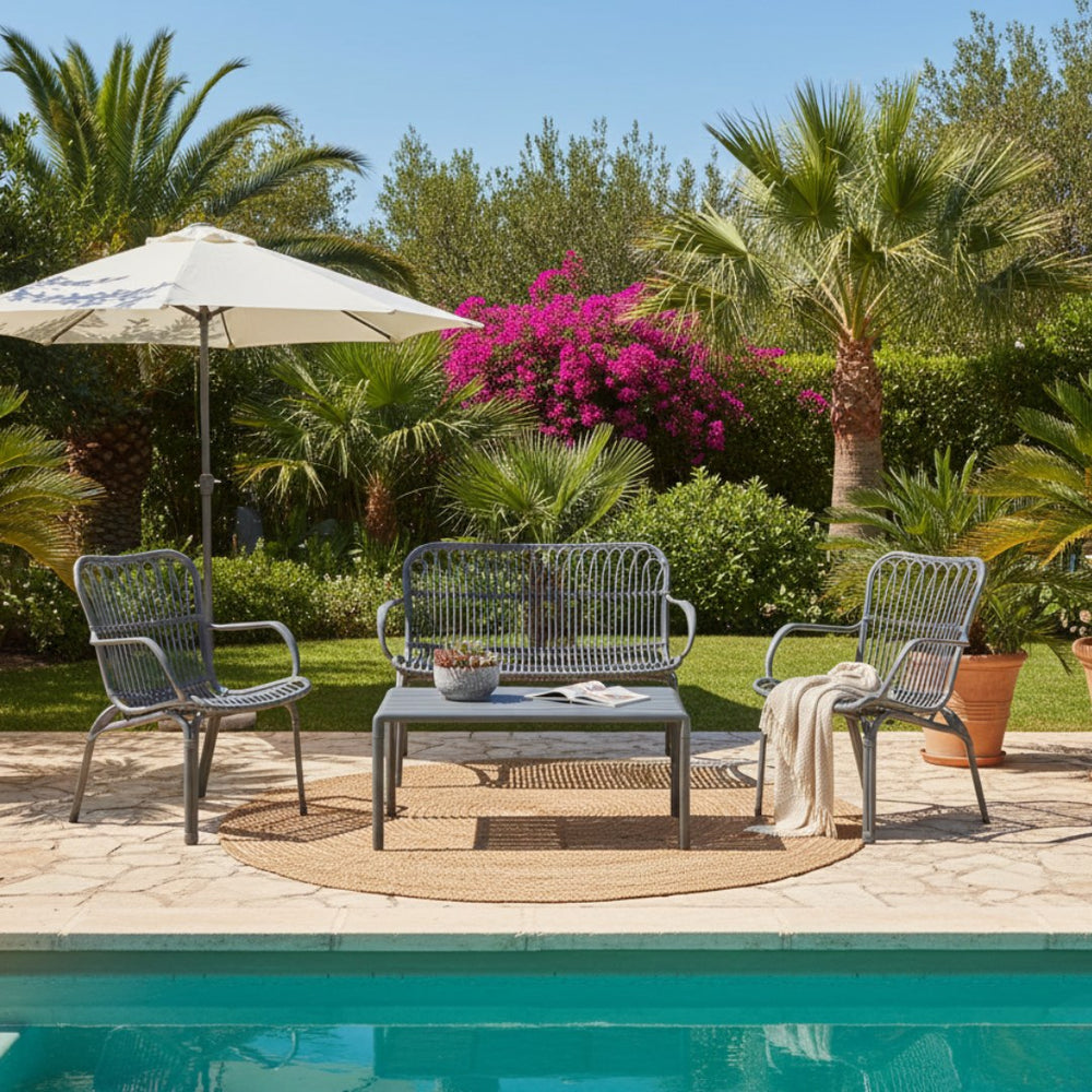 Marcolo grey outdoor bistro set on a stone patio in a garden.