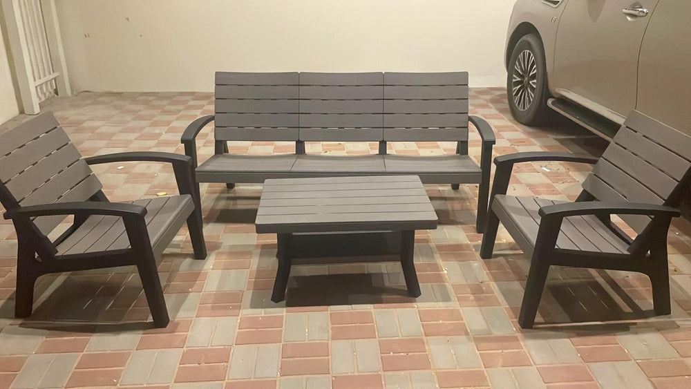 Customer's grey slatted wood-look outdoor sofa set with armchairs on a tiled villa patio