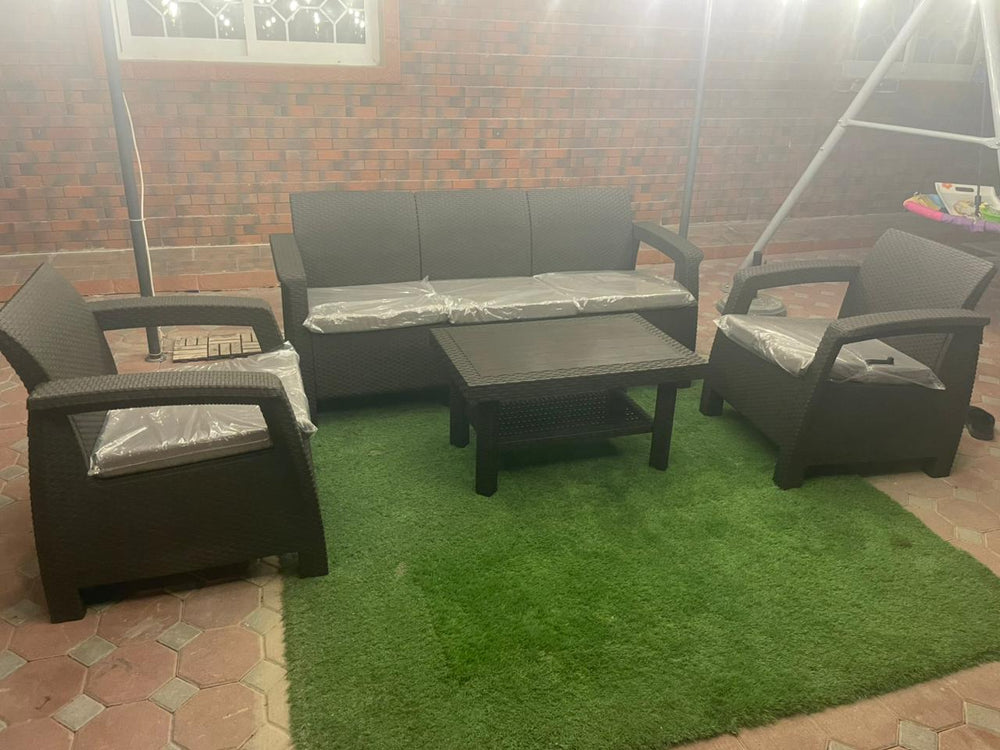 Customer's dark brown Havana rattan-look 5-seater sofa set on artificial grass in a villa courtyard