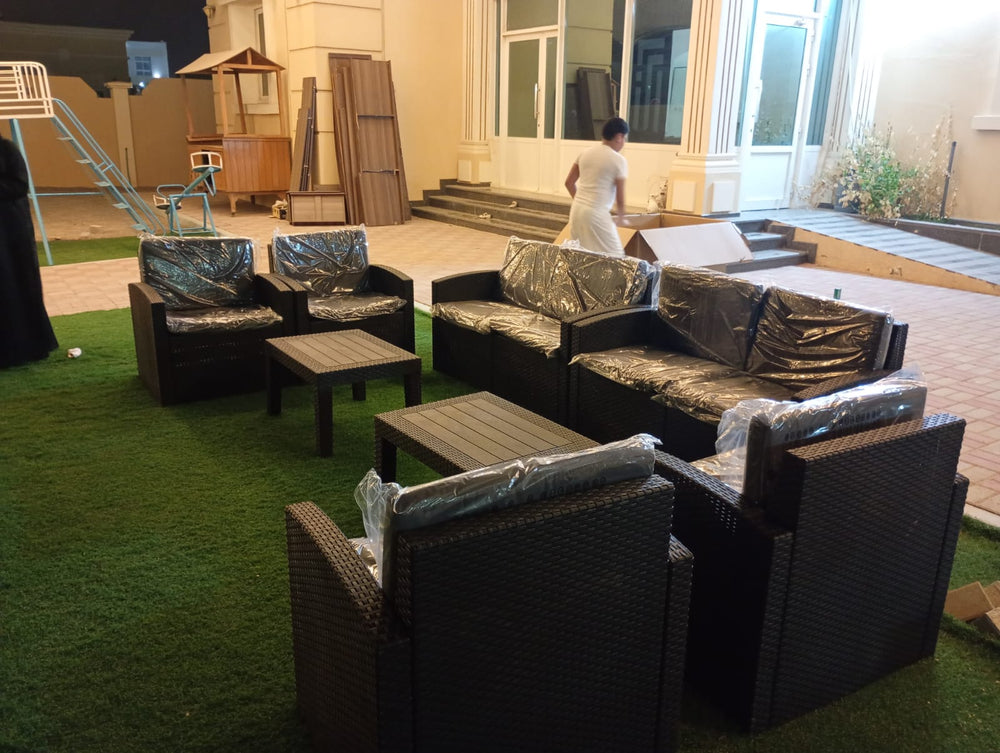 Two dark brown Havana rattan-look sofa sets on artificial grass in a customer's villa garden