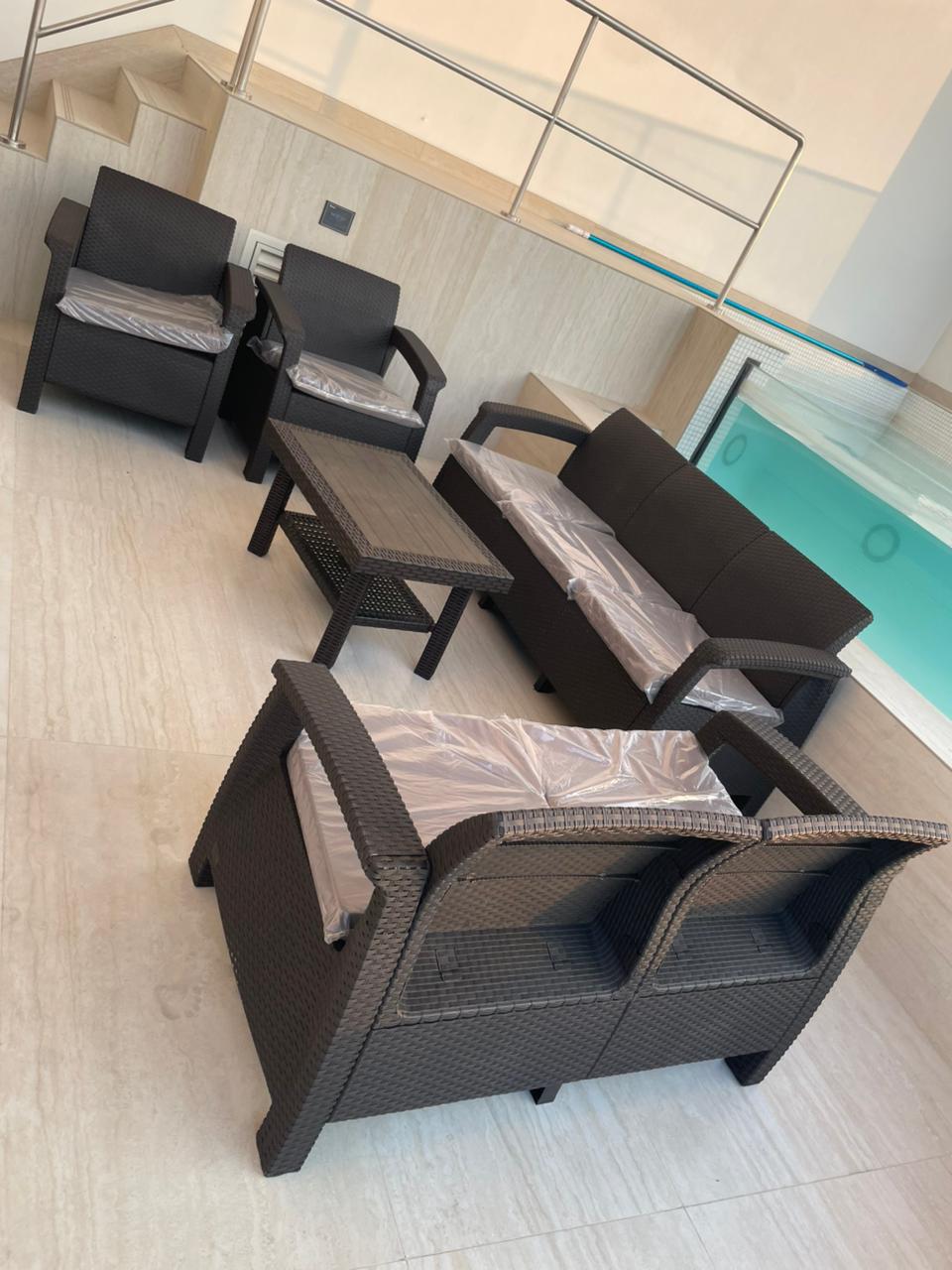 Customer's dark brown Havana rattan-look sofa set beside a rooftop swimming pool