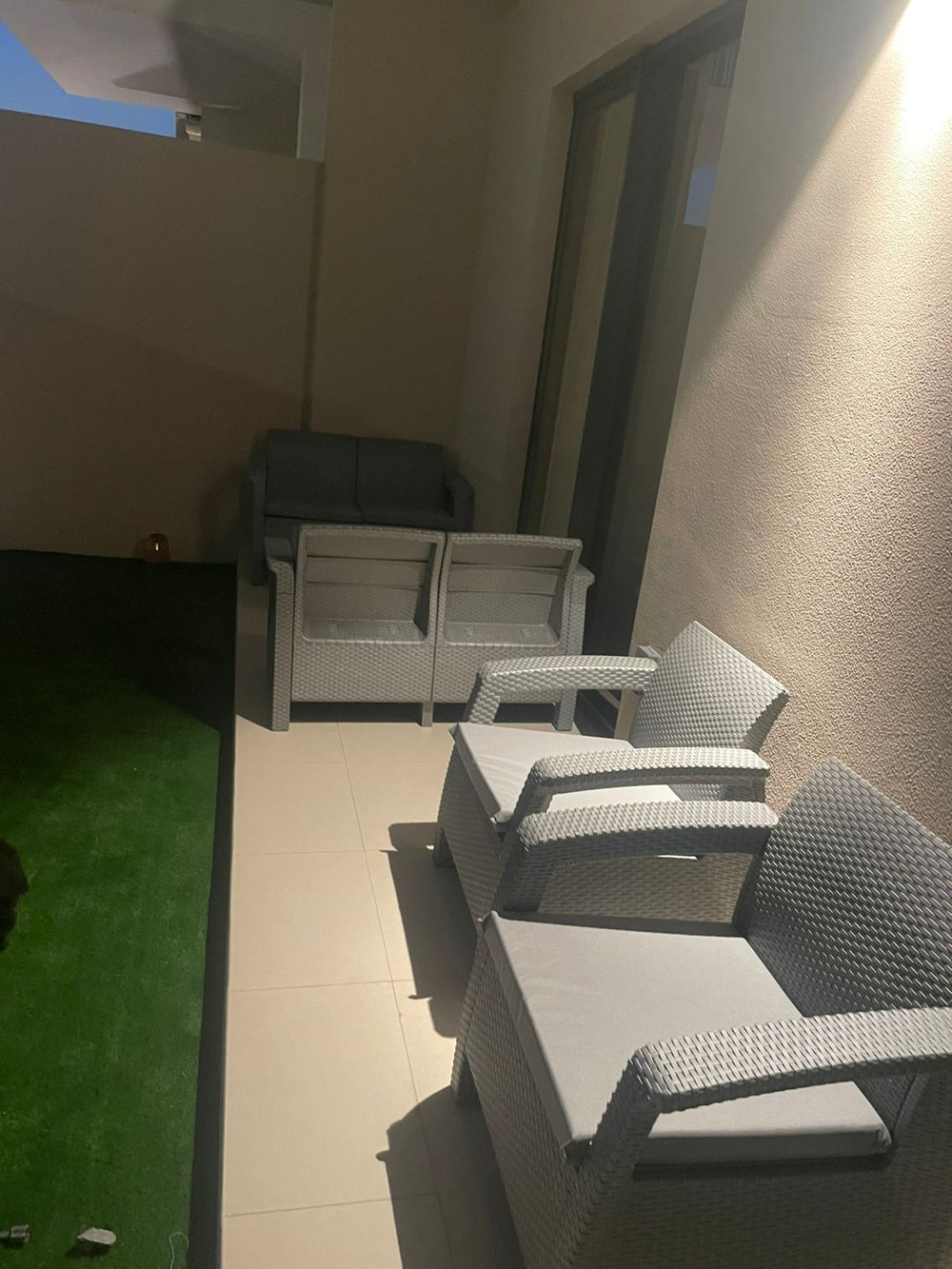 Customer's grey Havana rattan-look sofa set on a narrow apartment balcony
