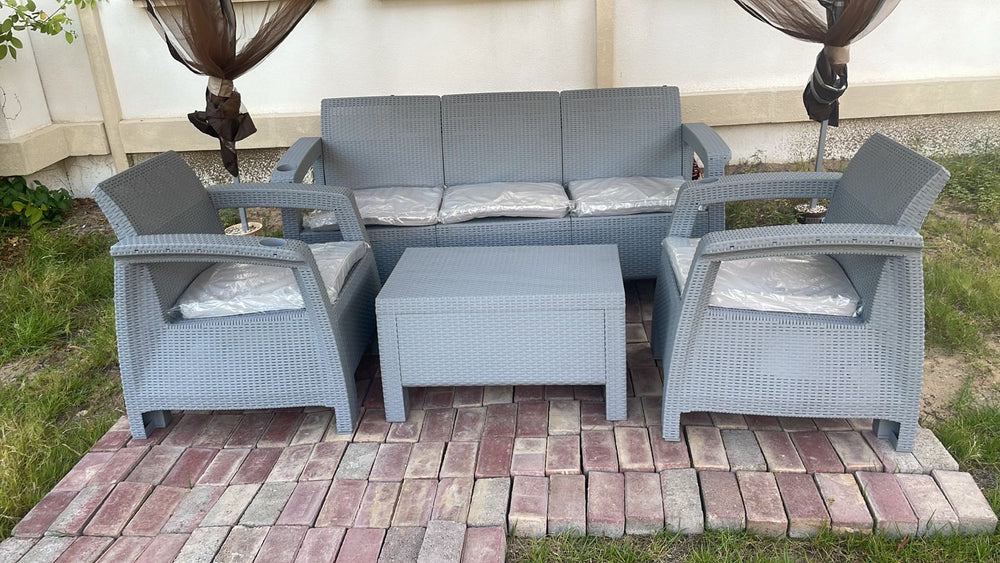 Customer's grey Havana rattan-look 5-seater sofa set on grass and brick pavers in a UAE garden