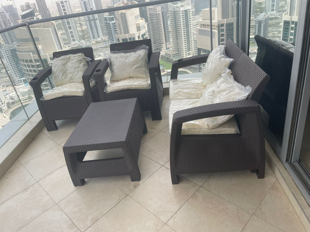 Customer's dark brown Havana rattan-look 4-seater sofa set on a Dubai Marina high-rise balcony