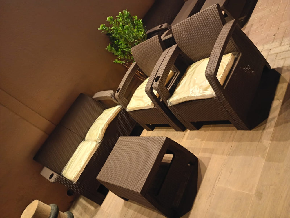 Dark brown Havana rattan-look sofa set with cream cushions seen from above