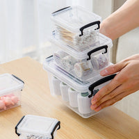 Marcolo clear storage boxes with black latches stacked and filled with small items