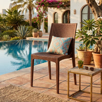 Marcolo Queen rattan-style dining chair, dark brown, beside a swimming pool